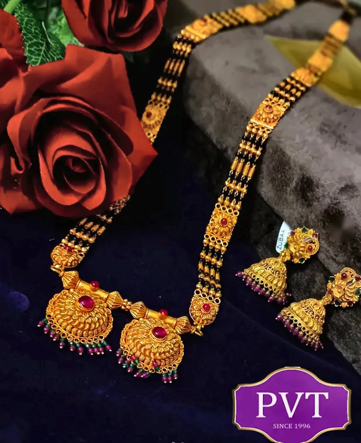 Long gold and black-bead mangalsutra with twin pendants and matching jhumka earrings